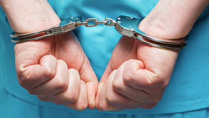 doctor in handcuffs