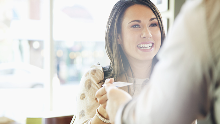 woman handing over credit card