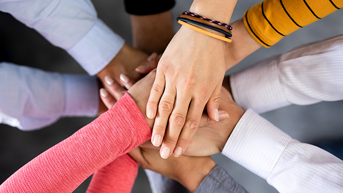 Stack of hands. Unity and teamwork concept.