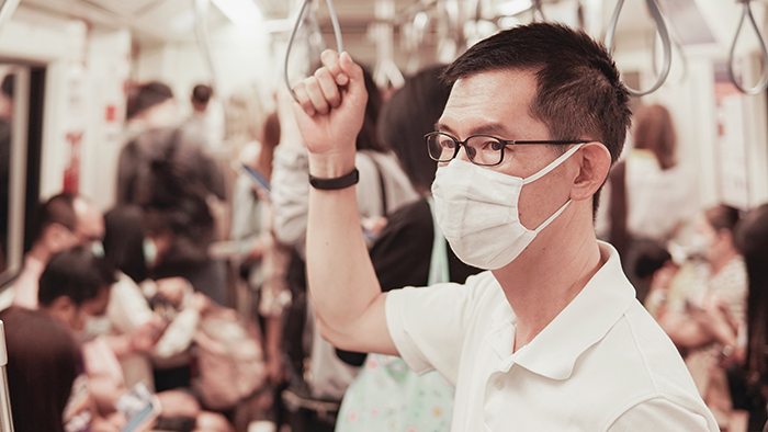 Middle aged Asian man wearing glasses and medical face mask on p