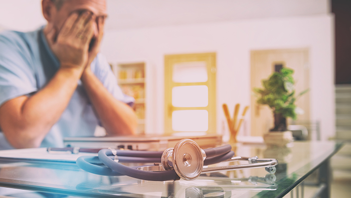 Overworked doctor in his office