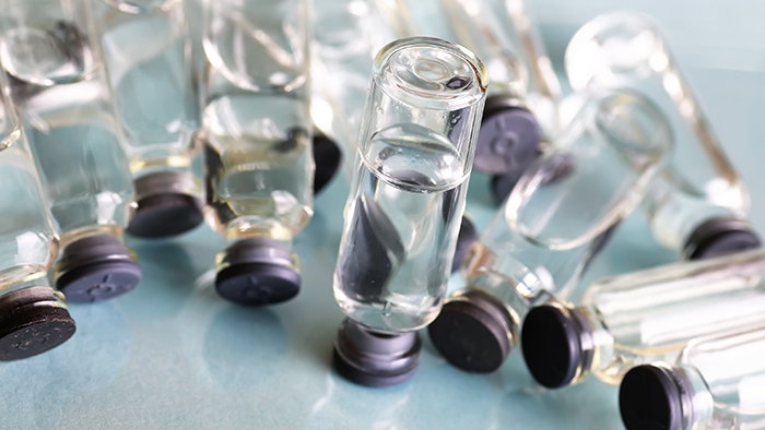 transparent vials of medicine