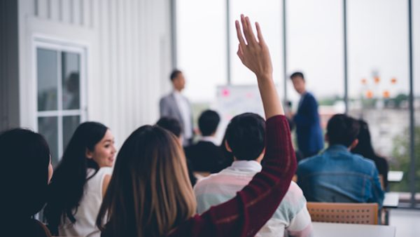 Woman raises her hand to speak