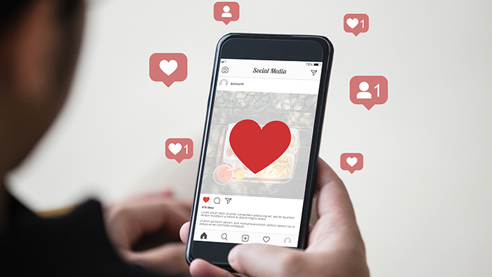 Man holding smartphone using mobile application for instagram on